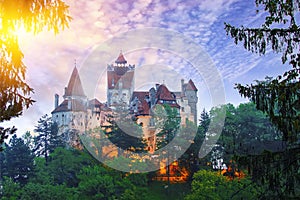 Landscape with medieval Bran castle known for the myth of Dracula at sunset