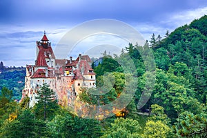 Landscape with medieval Bran castle known for the myth of Dracula at sunset