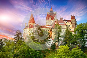 Landscape with medieval Bran castle known for the myth of Dracula at sunset