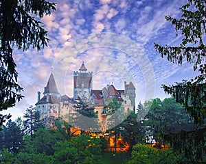 Landscape with medieval Bran castle known for the myth of Dracula at sunset