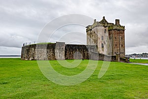 Landscape with medieval Broughty Castle in Dundee, Scotland at overcast weather