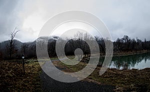 Landscape with misty morning fog in the Forest Lake or Beautiful forest lake in the morning at winter time. Azerbaijan nature.