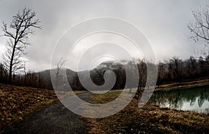 Landscape with misty morning fog in the Forest Lake or Beautiful forest lake in the morning at winter time. Azerbaijan nature.