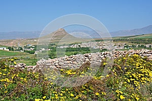 Zendan-e Soleyman or Prison of Solomon peak and historical wall of Takht-e Soleiman in Takab photo