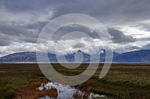 Landscape with mountain in clouds near Hofn village