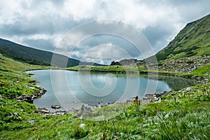 Landscape with mountain lake under the beautiful clouds