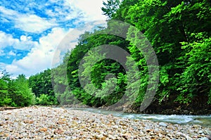 Landscape mountain river with big rocks on the shore