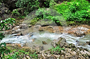 Landscape mountain river with big rocks on the shore