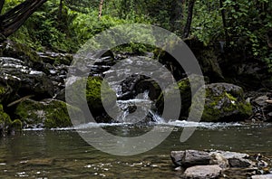 Landscape mountain river with waterfalls and rapids