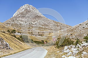 Mountain road and Camicia peak, near Capo la Serra pass, Abruzzo, Italy photo