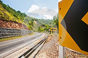 Landscape of mountain road curves with curve marker warning signs