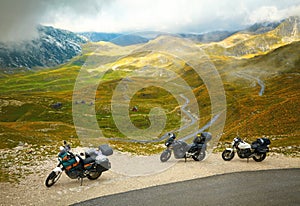 Landscape with mountain road and three motorbikes