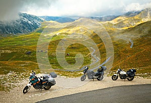 Landscape with mountain road and three motorbikes photo