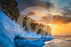 Landscape of Mountain at sunset with natural breaking ice in frozen water on Lake Baikal, Siberia, Russia