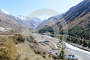 Landscape of mountain valley, panorama of city Sangla Valley, Chitkul village, from the hiking trail in Himalayas Mountains, in