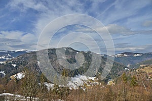 Landscape with mountain village in the Apuseni mountains at the end of winter in Romania