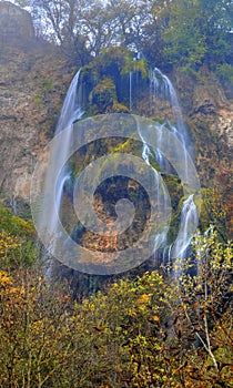 Landscape with mountain waterfall and colorful autumn forest