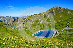 Landscape of mountains of Alps in summer with flowers and a lake in Portes du Soleil, France
