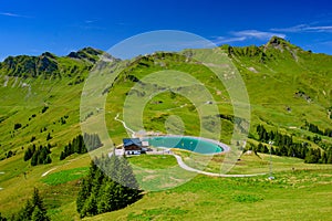 Landscape of mountains of Alps in summer with green meadow and a lake in Portes du Soleil, Switzerland