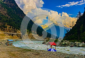 Landscape in mountains with blue skys, pure green water, old traditional wooden beds and trees in swat valley Pakistan