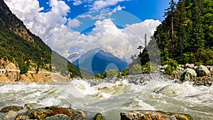 Landscape in mountains with blue skys, pure green water, old traditional wooden beds and trees in swat valley Pakistan