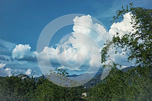 Landscape with mountains covered with forest and clody sky