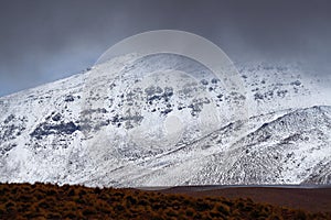 Landscape of mountains in the high lands of Chile near the border with Bolivia. Snow-covered landscapes of the Andes and the