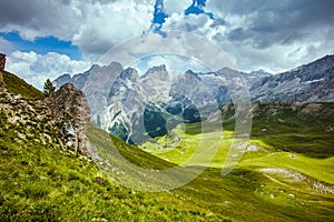 landscape with mountains, hills, clouds and grass