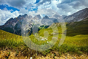 landscape with mountains, hills, clouds and grass