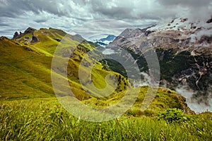 landscape with mountains, hills, clouds, grass and trees