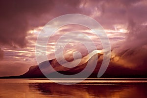 Landscape. Mountains and lake in mist in morning with yellow col