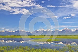 Landscape with mountains reflecting in  water on summer day. Buryatia, Tunkinskaya valley. Russia