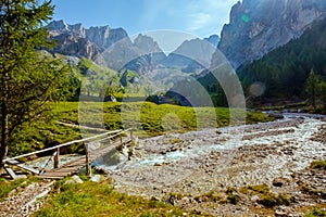 landscape with mountains, river, trees and bridge