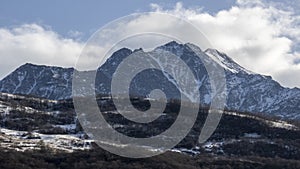 Landscape of mountains. Stunning gloomy bird's-eye view of a high snowy mountain peak