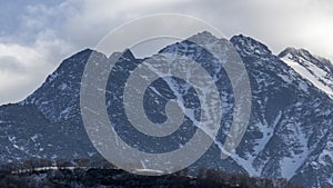 Landscape of mountains. Stunning gloomy bird's-eye view of a high snowy mountain peak