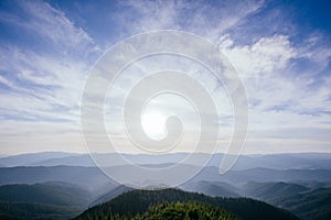 The landscape of mountains under sky with clouds