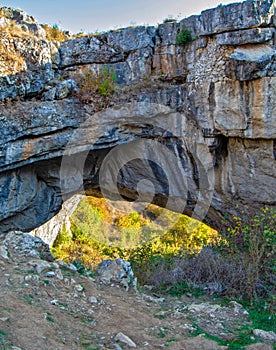 Landscape with natural rock bridge formed by a collapsed cave, known as God`s Bridge or