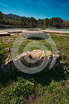 Landscape in nature with a lake, an abandoned well