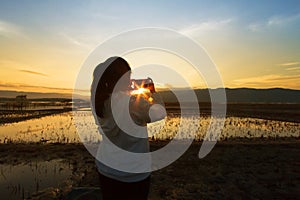 Landscape nature scene of women shooting the photo at dramatic sky