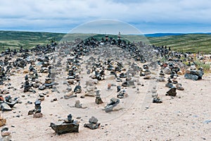 Landscape with neatly arranged stones near Teriberka. The open space of the northern lands in clear sunny weather.