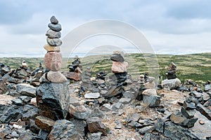 Landscape with neatly arranged stones near Teriberka. The open space of the northern lands in clear sunny weather.