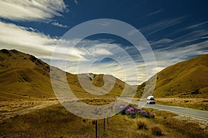 Landscape New Zealand - South Island - landscape near Southern Alps - road between mountains, blue sky with clouds