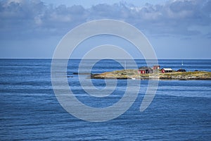 Landscape of the Norwegian coast with lovely red houses on the b