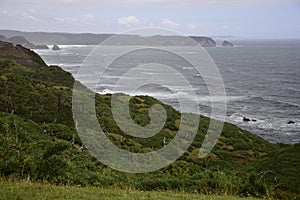 The landscape of the ocean and the rocky coast in Cucao on the way to Muelle de las Almas (Dock of Souls