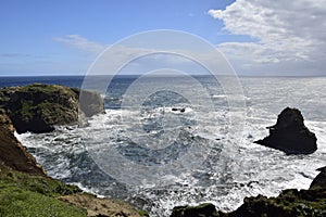 The landscape of the ocean and the rocky coast in Cucao on the way to Muelle de las Almas (Dock of Souls