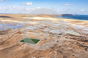 Landscape with ocean, salinas and sports field in Sal, Cape Verde Islands photo