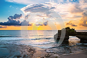 Landscape, Ocean in sunset with cliff and natural arch at Tanah lot, Bali