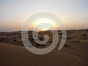 Landscape of sandy desert in sunset photo