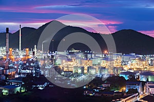 Landscape of oil refinery industry with oil storage tank in night