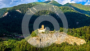 Landscape with old castle in sunset light, Switzerland. Village in Swiss Alpine terrain